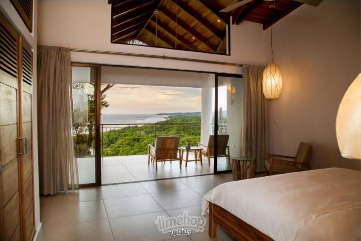 Ocean-view room at LaGarta Lodge, with forest and coast beyond the terrace